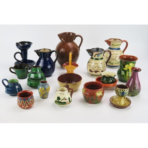 1146 - A collection of Watcombe pottery wares includes motto wares, jugs , bowls etc