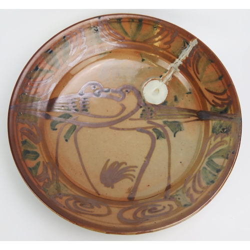 1157 - A Seth Cardew lustre pottery plate, decorated with two birds enclosed in a banded border 31cm diamet... 