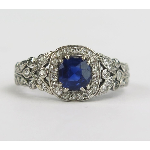 117 - A Pretty Sapphire and Old Cut Diamond Ring with pierced foliate shoulders and diamond set around the... 