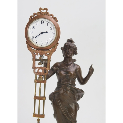 1181 - A bronzed metal mystery timepiece, modelled as a young lady standing in a flowing dress holding alof... 