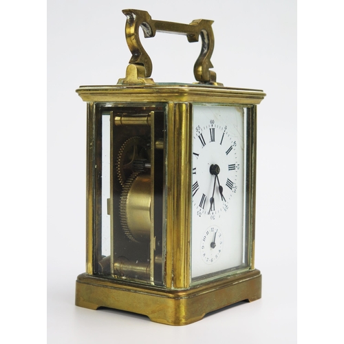 1192 - A lacquered brass carriage clock, the 6cm Roman dial with subsidiary alarm dial, the movement with p... 