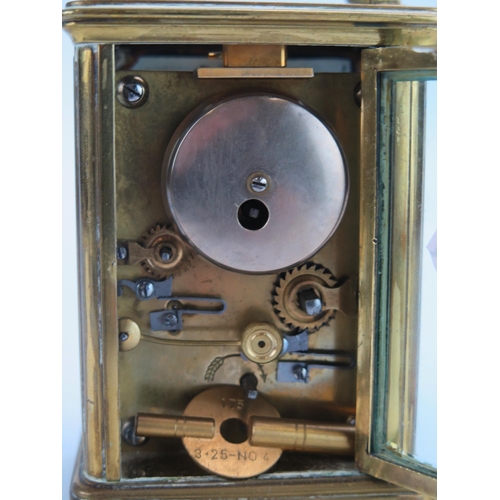 1192 - A lacquered brass carriage clock, the 6cm Roman dial with subsidiary alarm dial, the movement with p... 