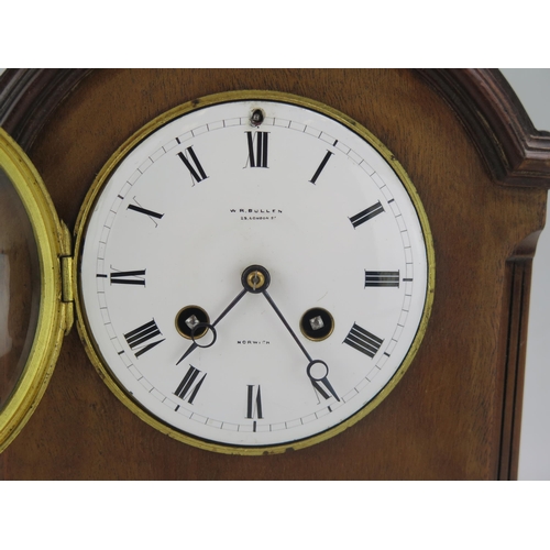 1193 - W R Bullen, Norwich, a mahogany Georgian style bracket clock, of arched outline with 11cm Roman dial... 