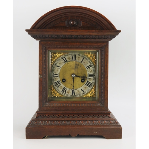 1195 - An Edwardian oak cased mantel clock, of arched outline, the 15cm brass dial with silvered chapter ri... 