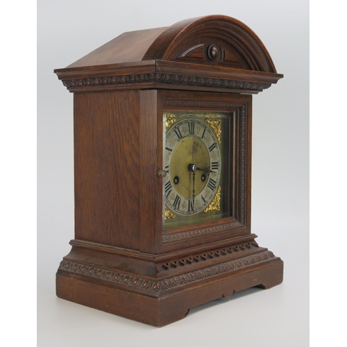 1195 - An Edwardian oak cased mantel clock, of arched outline, the 15cm brass dial with silvered chapter ri... 