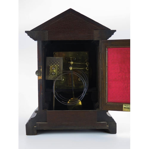 1195 - An Edwardian oak cased mantel clock, of arched outline, the 15cm brass dial with silvered chapter ri... 