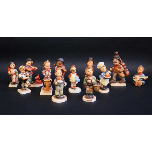 1210 - A collection of twelve Hummel figures including child street musicians, chef and other figures. (12)