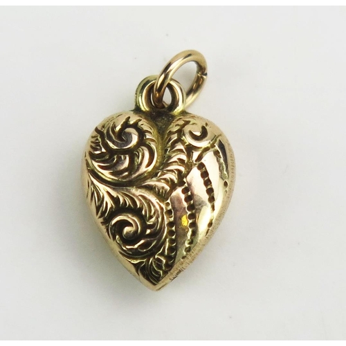 123 - An Antique Precious Yellow Metal Heart Shaped Pendant with chased foliate scroll decoration, 16mm dr... 