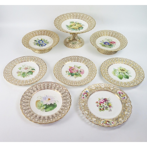 1244 - A late 19th century porcelain part fruit service decorated with painted botanical specimens, enclose... 