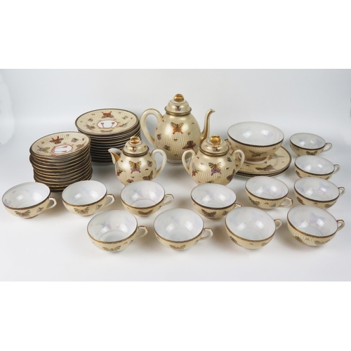 1250 - An early 20th century Japanese eggshell porcelain, twelve setting tea service decorated with butterf... 