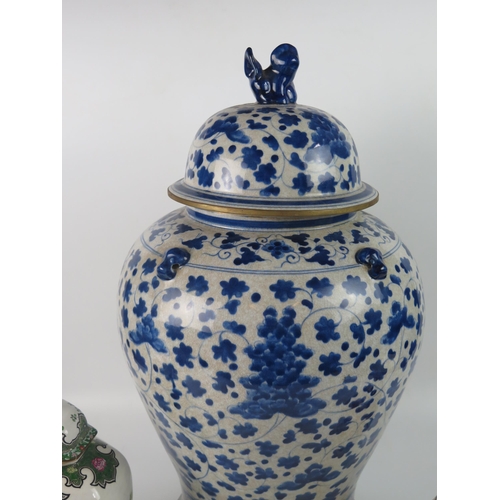 1252 - A large modern Chinese blue and white vase and cover, of ovoid outline, the domed cover surmounted b... 