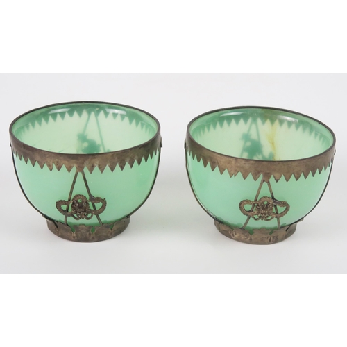 1255 - A pair of green glass bowls with white metal mounts, 7cm diameter.