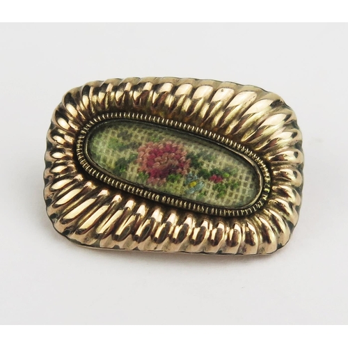 127 - A 19th Century Precious Yellow Metal Brooch with inset needlework panel, 23x15.6mm, KEE tested as 9c... 