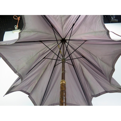 1273 - A good quality Victorian parasol, with pale purple canopy, having a gilt metal mounted faux zebra wo... 