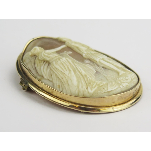 128 - A 19th Century Shell Cameo Brooch in a precious yellow metal setting, decorated with a classical sce... 