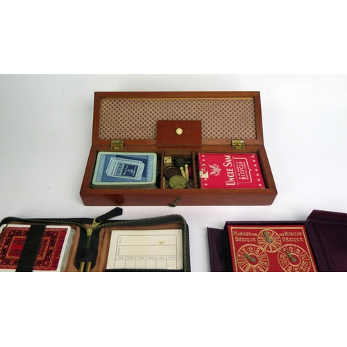 1289 - A mahogany folding cribbage board containing two packs of playing cards, Hoyle gaming counters, toge... 