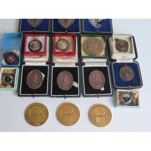 1295 - A collection of bronze and other medallions and awards, most boxed or cased. (a lot)