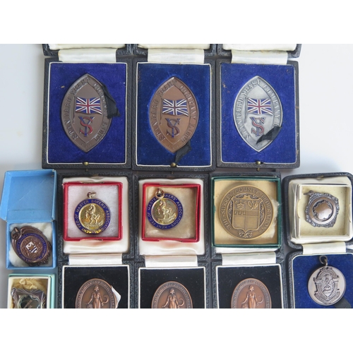 1295 - A collection of bronze and other medallions and awards, most boxed or cased. (a lot)