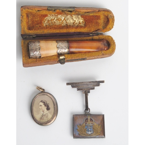 1304 - A Meerschaum and amber silver mounted cheroot holder, sterling silver sweetheart brooch and a locket... 