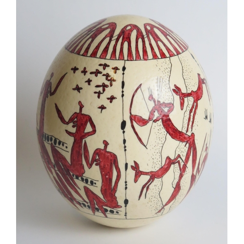 1316 - An ostrich egg, decorated with painted tribal warriors and hunting scenes,