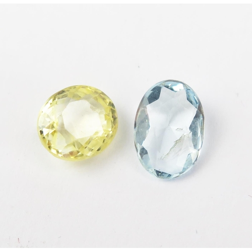 154 - A Yellow Sapphire (c. 8.2x7.2x5.5mm) and a pale blue stone