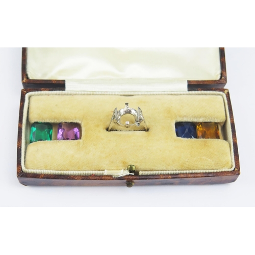 155 - A Cased Silver Ring with four interchangeable paste specimens, size J