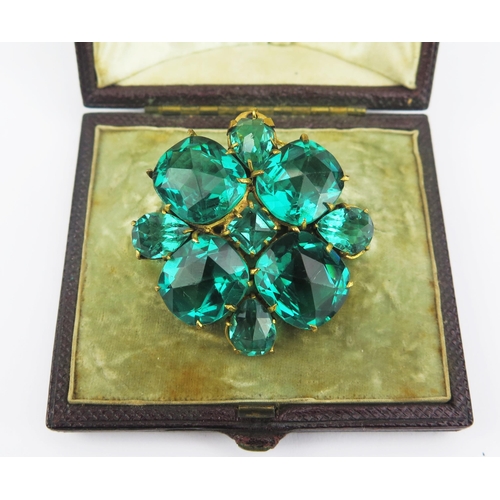 157 - A Cased Green Paste Brooch in a yellow metal mount, 39mm, Joseph Silvani of Brighton box