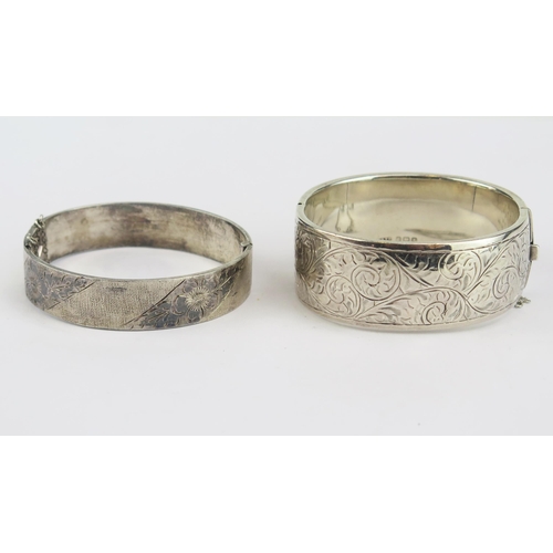 158 - Two Silver Hinged Bangles with chased decoration, both hallmarked, 23.8mm wide and 13.7mm, 75.55g