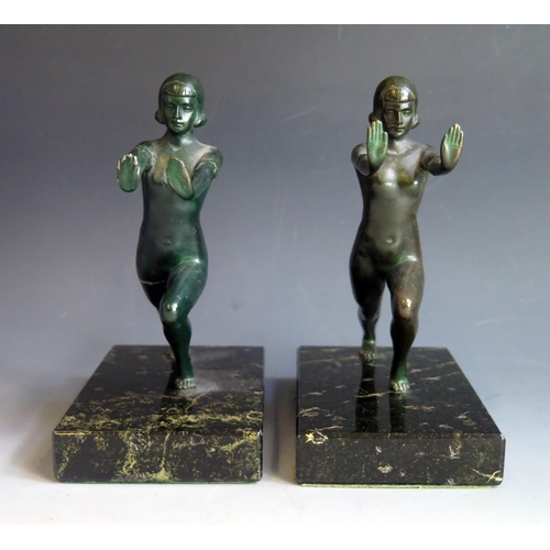 1622 - A pair of Art Deco period painted spelter bookends, modelled as nude females, raised on rectangular ... 