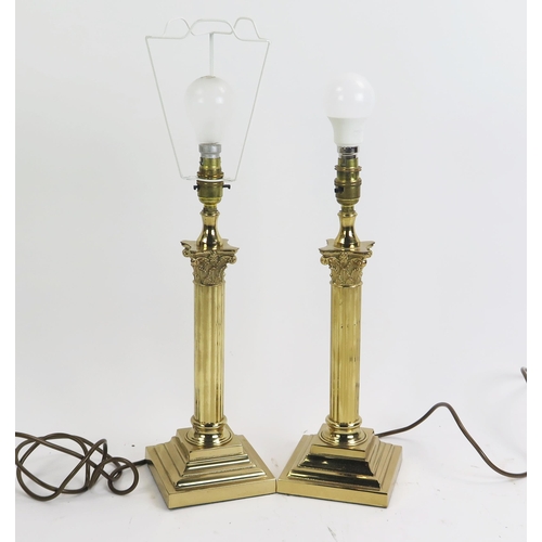 1634 - A pair of lacquered brass Corinthian column table lamps, on stepped square bases.