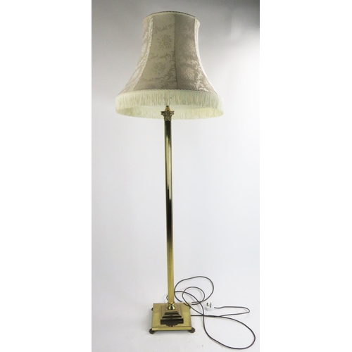 1635 - A lacquered brass Corinthian column standard lamp on a reeded column and square base raised on paw f... 