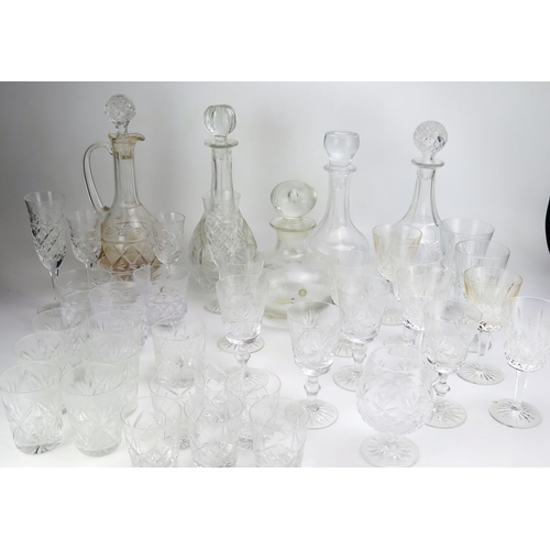 1636 - A collection of cut glass drinking vessels including wine glasses, tumblers, and assorted decanters.