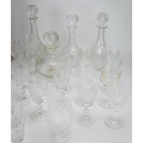 1636 - A collection of cut glass drinking vessels including wine glasses, tumblers, and assorted decanters.