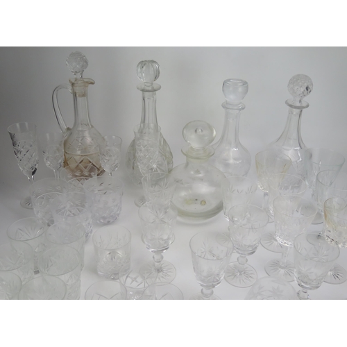 1636 - A collection of cut glass drinking vessels including wine glasses, tumblers, and assorted decanters.