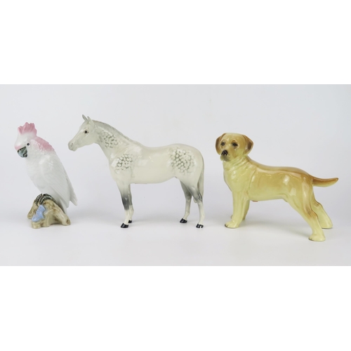 1644 - A Beswick dapple stallion, gloss glaze, 23cm long,  a continental porcelain figure of a parrot and a... 