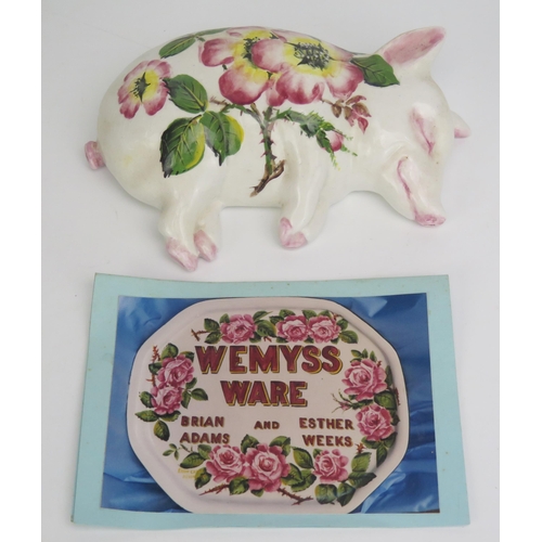 1645 - A Wemyss ware sleeping pig, with traditional painted rose decoration, signed B. Adams, impressed EXO... 