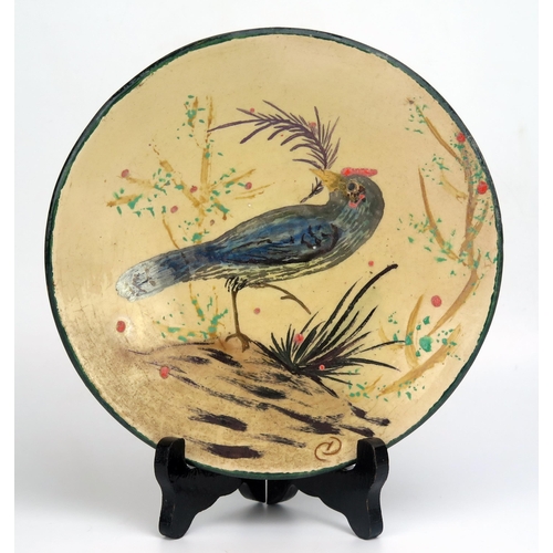 1646 - A Diaz Costa pottery plate, decorated with an exotic bird amongst shrubs, monogrammed CD, 21cm diame... 