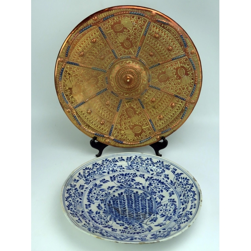 1656 - A Delft charger with blue and white foliate decoration, 34.5cm diameter, together with a lustre pott... 