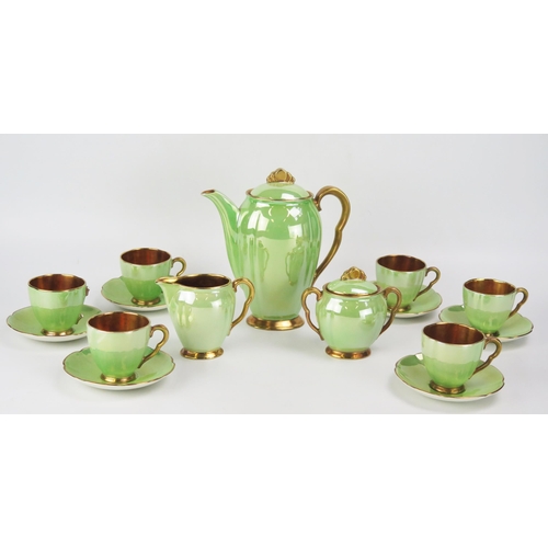 1657 - A Carlton ware coffee service, with pea green lustre glaze bordered in gilt, includes six cups , six... 