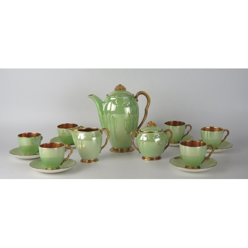 1657 - A Carlton ware coffee service, with pea green lustre glaze bordered in gilt, includes six cups , six... 