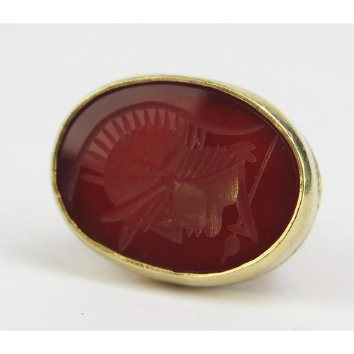 175 - A Hallmarked 9ct Gold and Carnelian Fob decorated with Romanesque helmeted soldier's head in profile... 