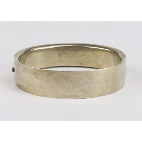 179 - A Victorian Precious White Metal Hinged Bangle, the inner rim engraved 