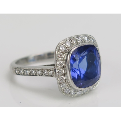 238 - A Platinum, Tanzanite and Diamond Dress Ring, c. 9.75x9.2mm principal millegrain set stone, 14.2x14.... 