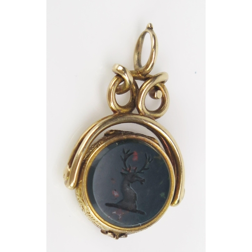 239 - An Unusual Antique Spinning Seal Fob Locket set with a carnelian matrix engraved with a pheasant and... 