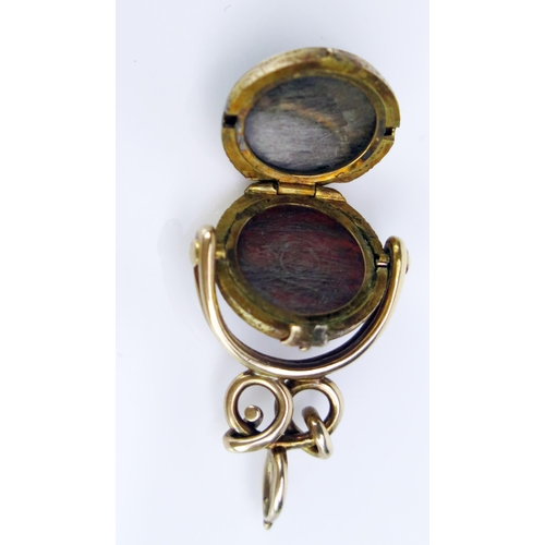 239 - An Unusual Antique Spinning Seal Fob Locket set with a carnelian matrix engraved with a pheasant and... 