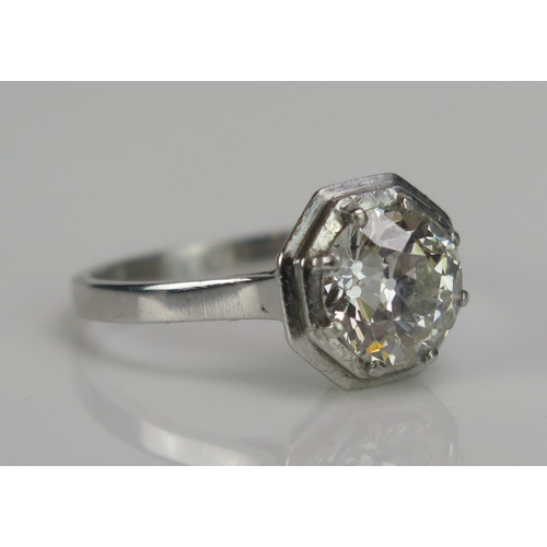 242 - A Diamond Solitaire Ring in a precious white metal setting with an hexagonal head, c. 7.6mm old Euro... 