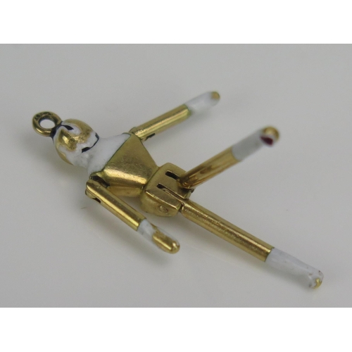 244 - An 18ct Gold and Enamel Articulated 'Peg Doll' Pendant or Charm, 32mm long, eagle head mark, 4.3g