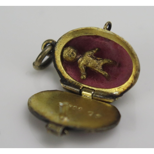 248 - A Continental Silver Gilt and Enamel Baby in a basket charm, 800 mark, 2.1g