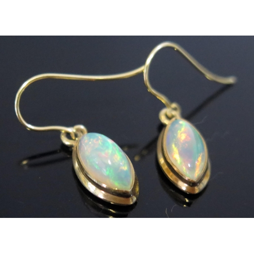 252 - A Pair of White Fire Opal Pendant Earrings in a silver gilt setting, 27.6mm overall drop, singlet sp... 