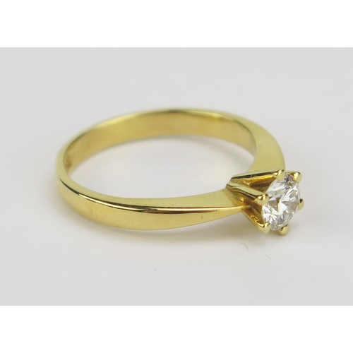 4 - An 18ct Yellow Gold and Diamond Solitaire Ring, 5.11mm claw set brilliant round cut, size M.5, stamp... 
